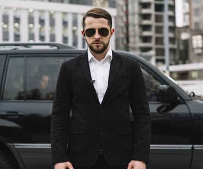 Bodyguard with a black dress,a bodyguard, a bodyguard giving security, a person giving security.