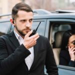 Bodyguard with a black dress,a bodyguard, a bodyguard giving security, a person giving security.