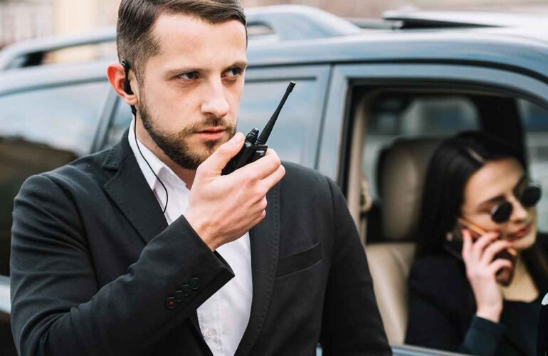 Bodyguard with a black dress,a bodyguard, a bodyguard giving security, a person giving security.