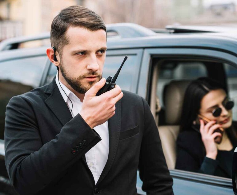 Bodyguard with a black dress,a bodyguard, a bodyguard giving security, a person giving security.