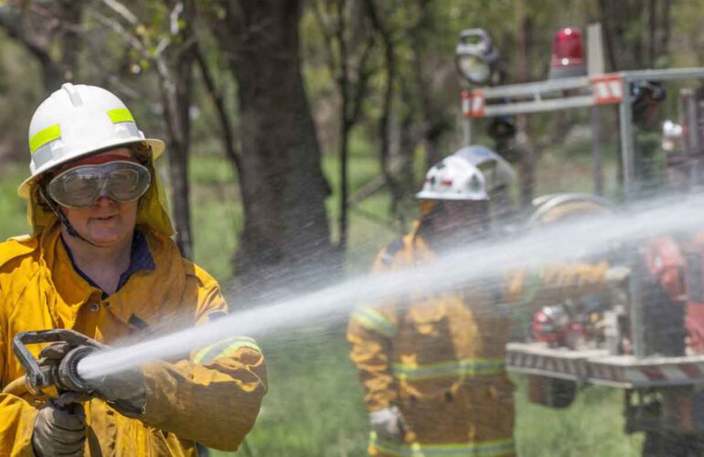Firefighters, water blowing on the fire, cooling the fire with water, women cooling the fire,