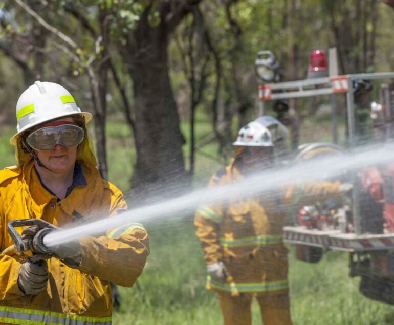 Firefighters, water blowing on the fire, cooling the fire with water, women cooling the fire,