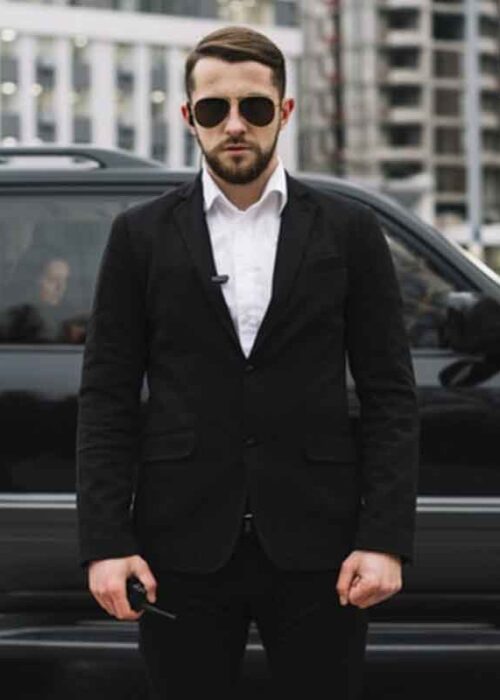 Bodyguard with a black dress,a bodyguard, a bodyguard giving security, a person giving security.